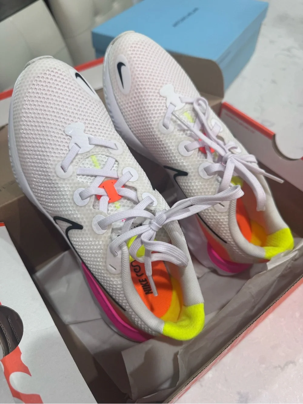 Nike White Running Shoe with Pink and Orange Accents
